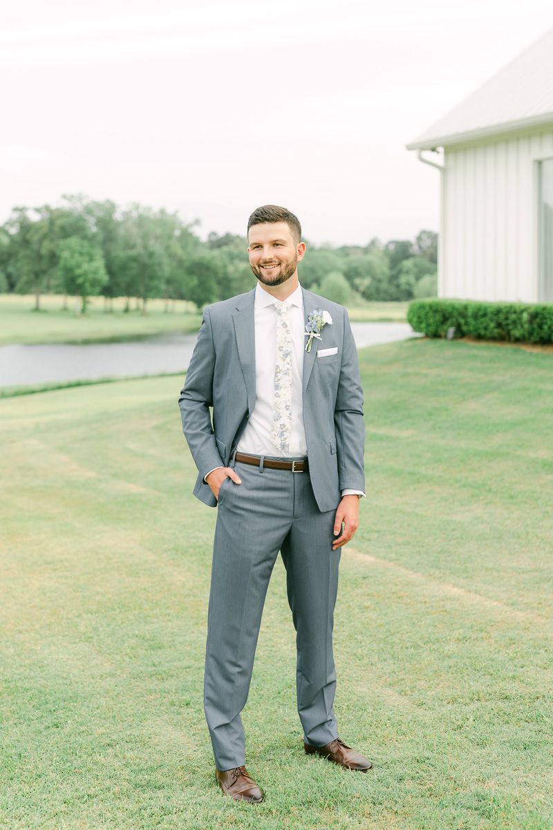 groom posing for photos on wedding day