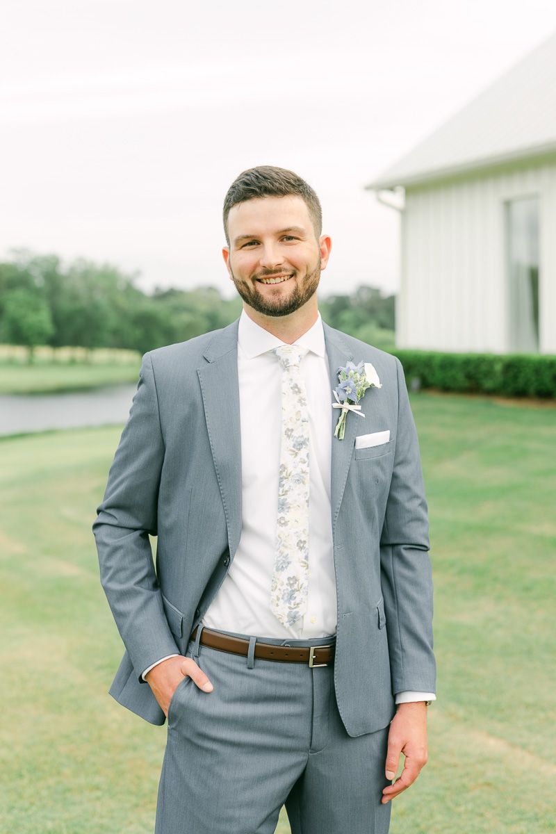 groom posing for photos on wedding day