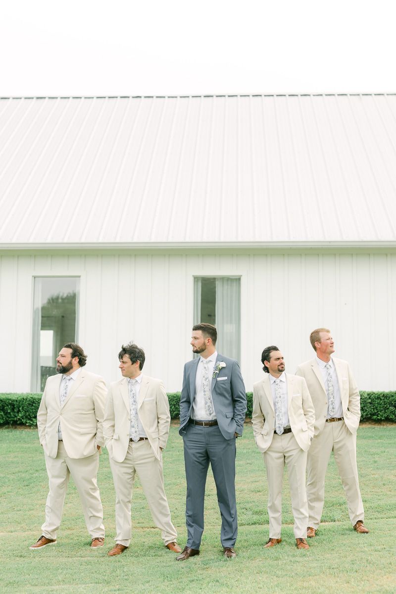 groomsmen in cream suits outside The Farmhouse chapel
