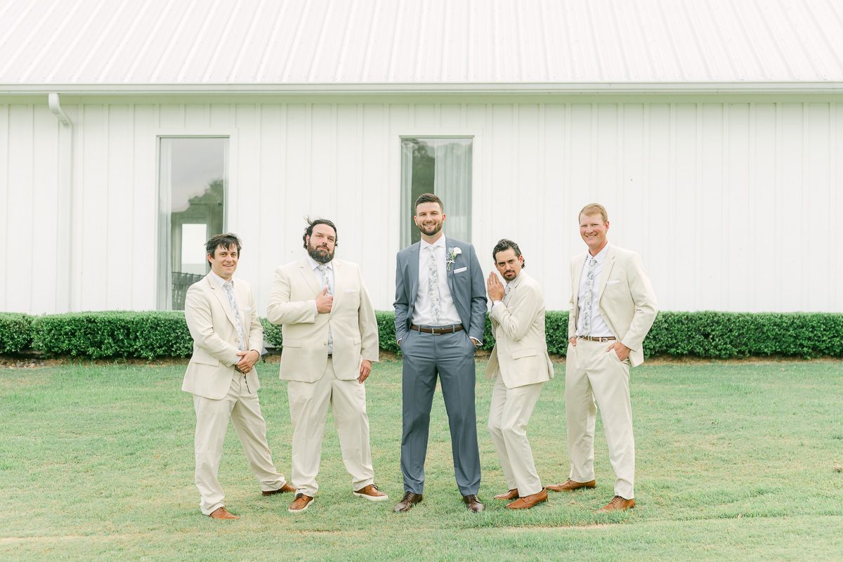 groomsmen in cream suits outside The Farmhouse chapel