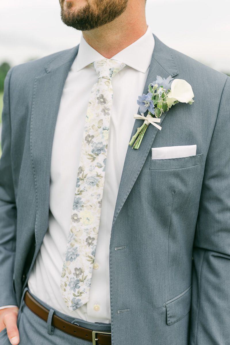 groom wearing blue floral tie for spring wedding