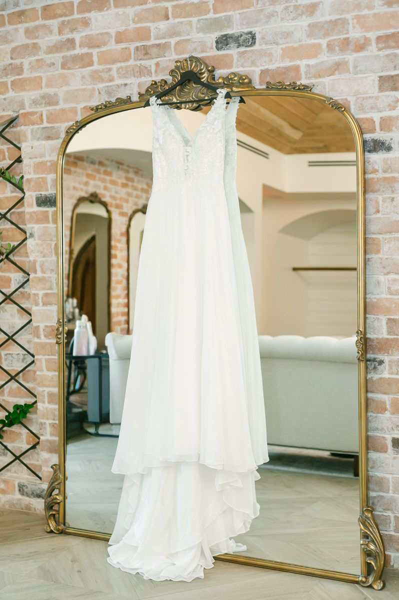 wedding dress hanging on mirror