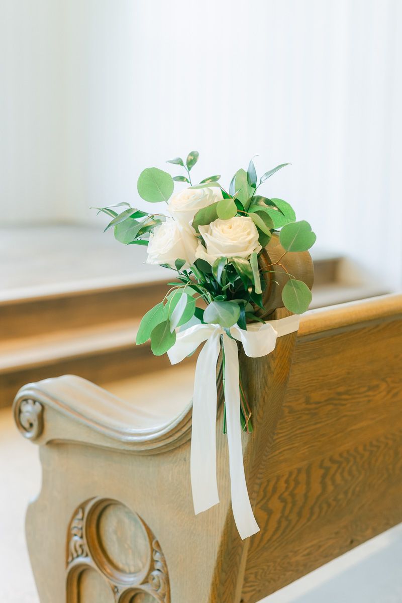 florals on pew at wedding