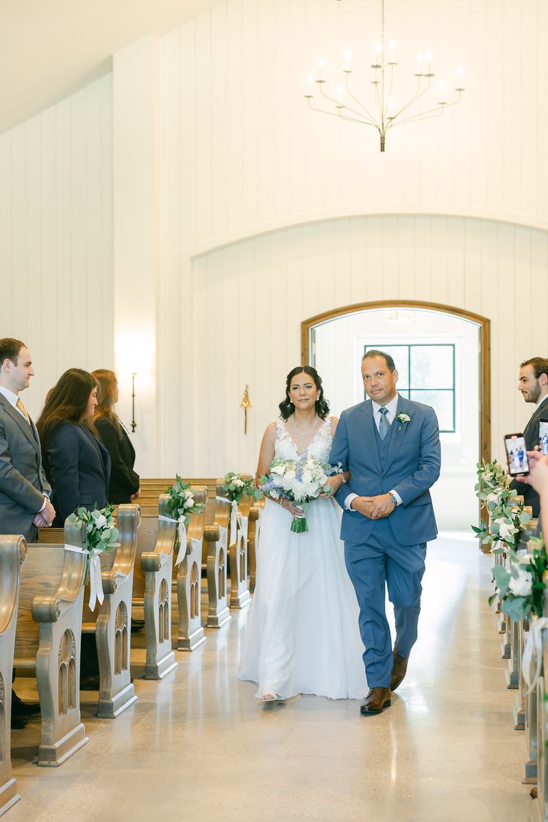 bride and dad walking up the aisle at wedding