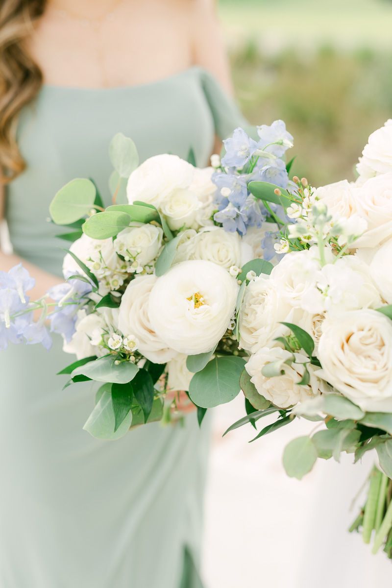 wedding bouquet with white flowers and pops of blue