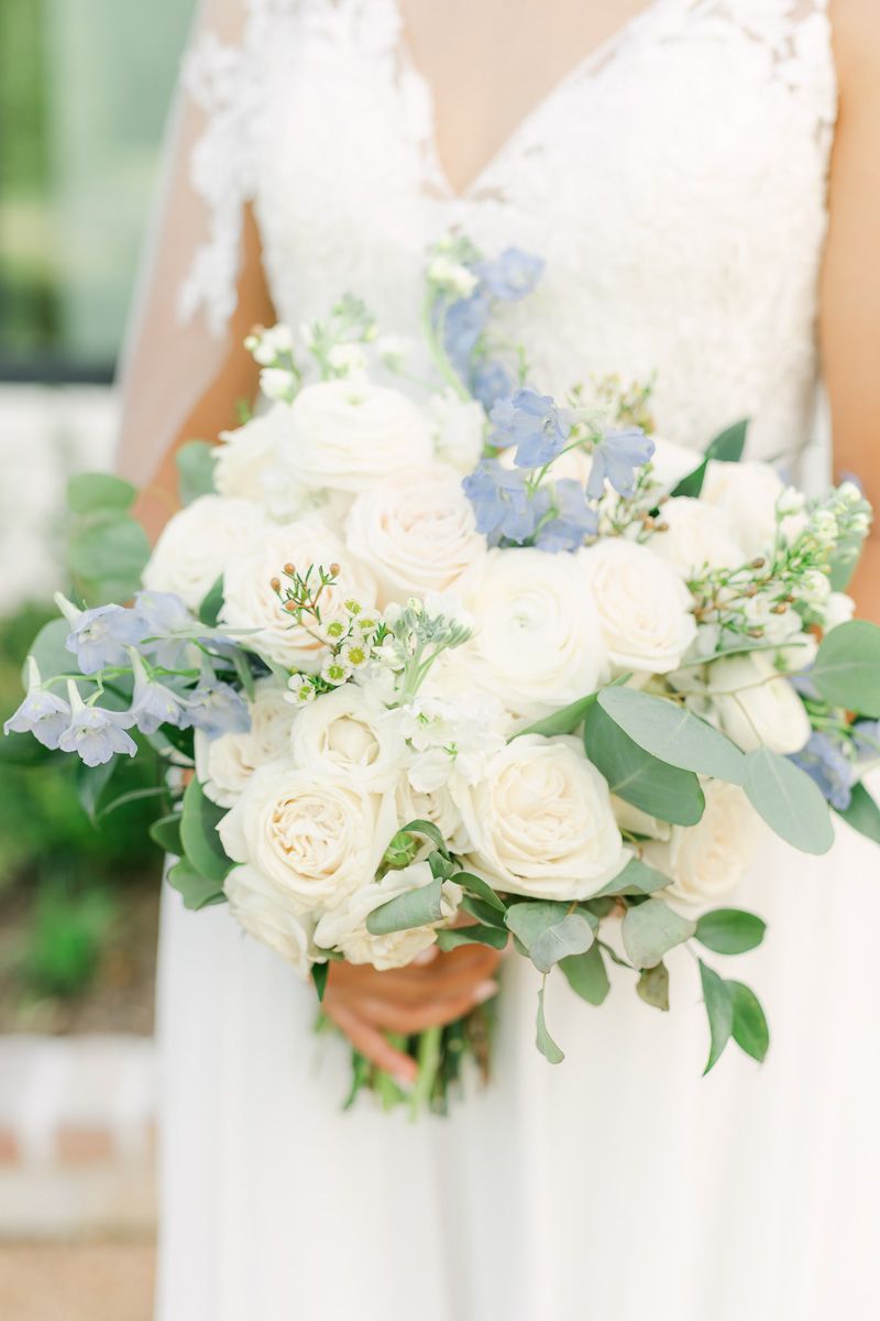 wedding bouquet with white flowers and pops of blue