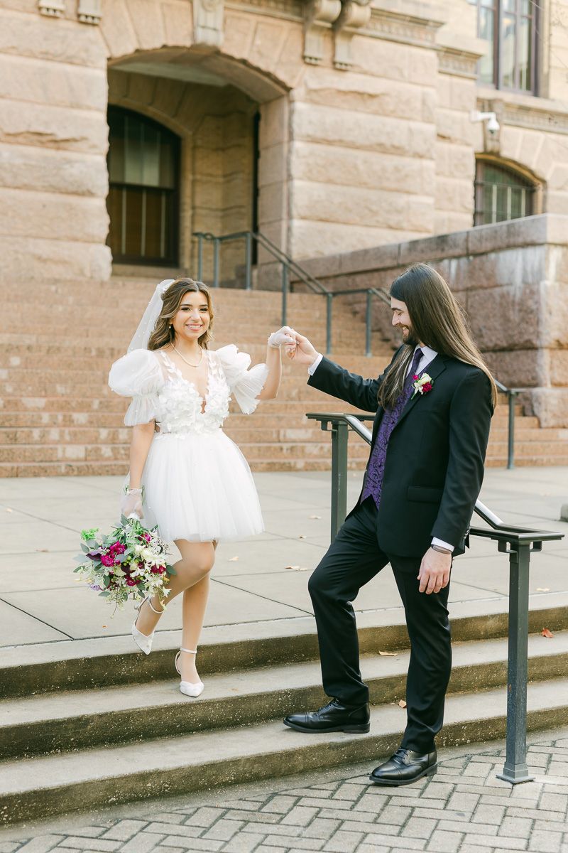 Couple on the steps of the 1910 Harris County Courthouse in Houston