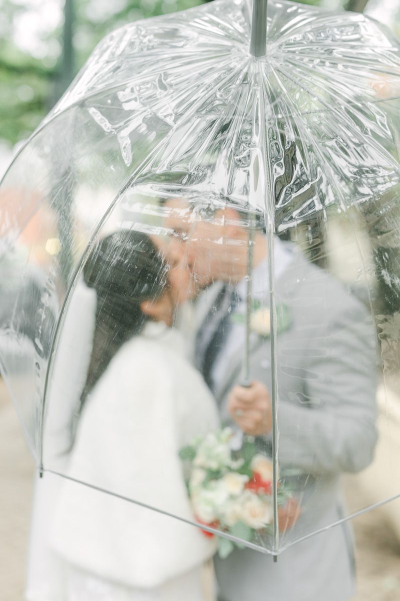 bride and groom walking outside the Houston courthouse with umbrella