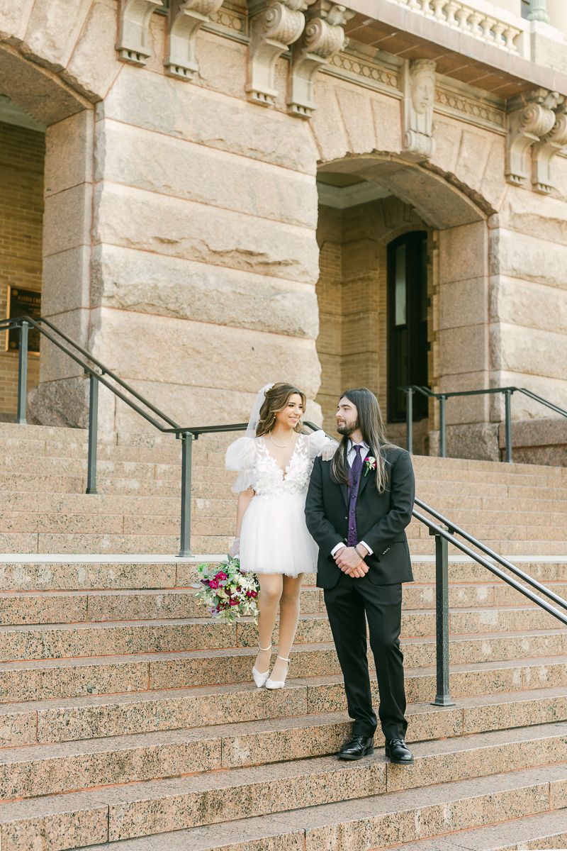 Couple on the steps of the 1910 Harris County Courthouse in Houston