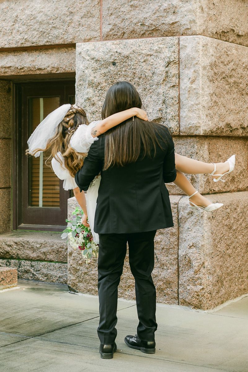 groom spinning bride at the 1910 Harris County Courthouse