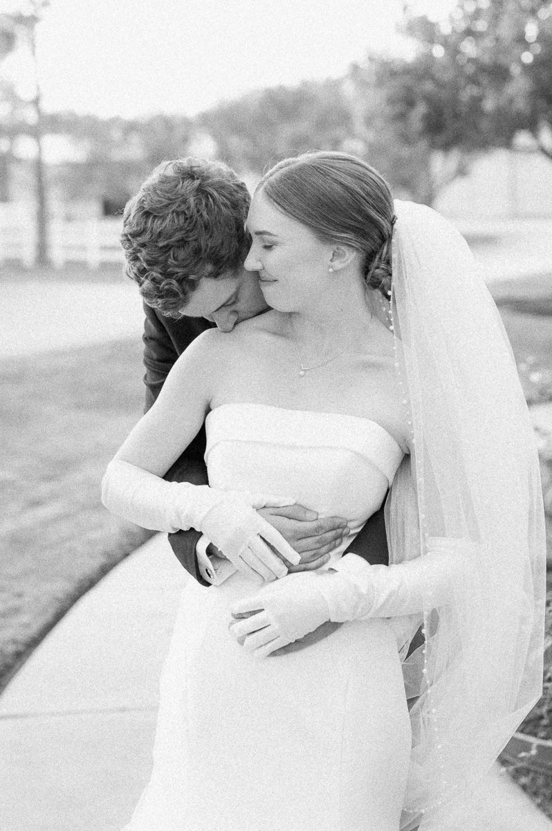 bride and groom posing for photos after wedding ceremony